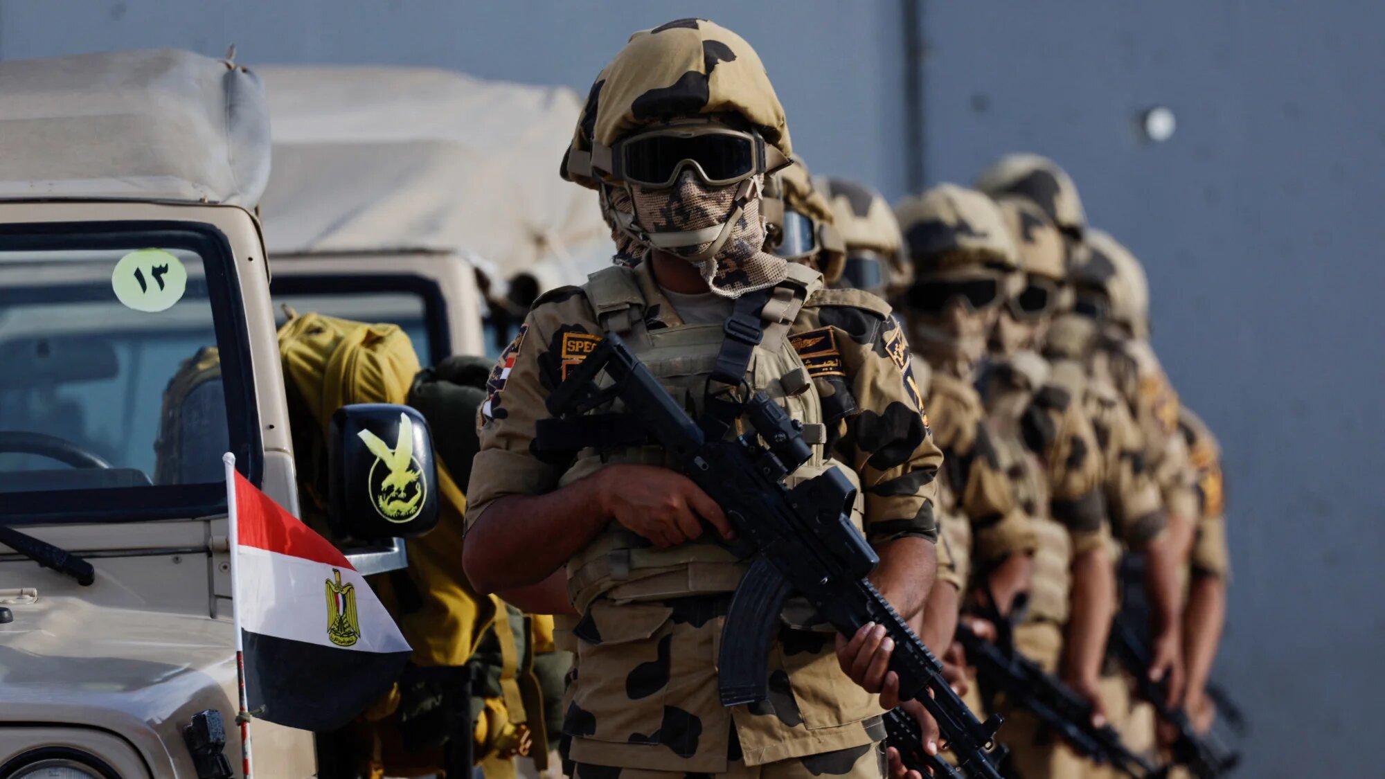 Egyptian soldiers stand guard during a visit by Prime Minister Mostafa Madbouli to the Rafah crossing border on 31 October 2023 (AFP/Khaled Desouki)