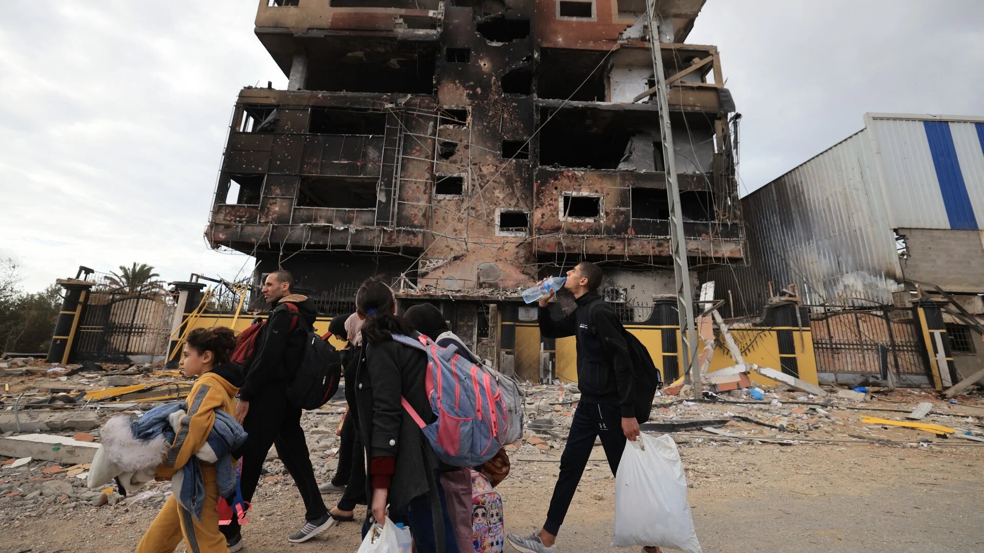 Palestinians fleeing the fighting in war-torn Gaza walk on Salaheddine road in the Zeitoun district of the southern part of the Gaza Strip on November 19, 2023 (AFP)