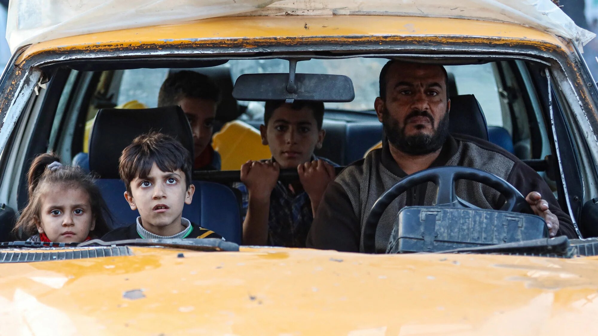 Residents of the refugee camp of Bureij arrive in Deir al-Balah in the central Gaza Strip following an Israeli ejection order, on 22December 2023 (AFP)