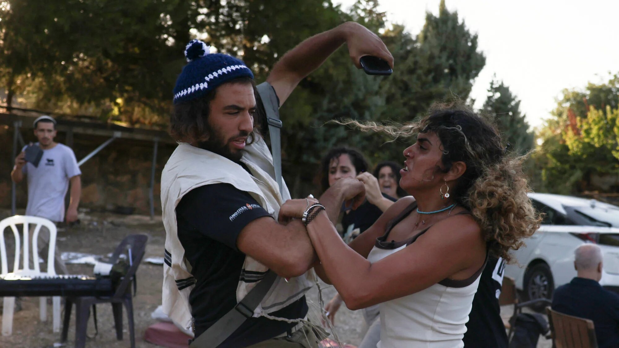 Armed Israeli soldiers are confronted by Palestinian residents of al-Makhrour in the occupied West Bank near Beit Jala village on 22 August 2024 (AFP/Hazem Bader)