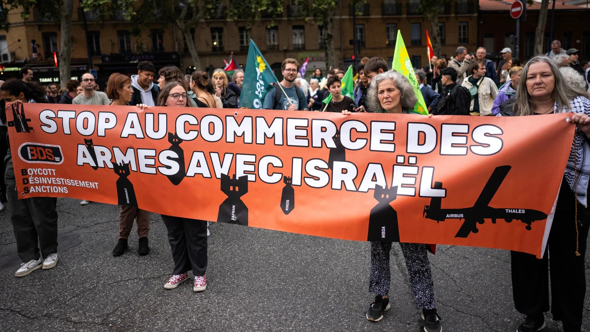 Demonstrators hold a banner reading 'Stop the arms trade with Israel' during a rally in support of the Palestinian people in Toulouse, southwestern France, on 11 September 2024 (Lionel Bonaventure/AFP)