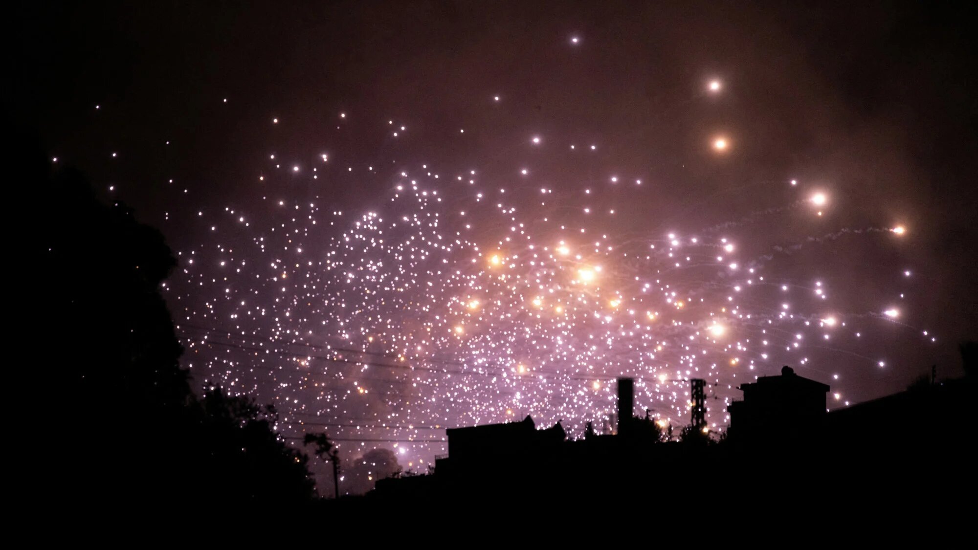 Sparks fly at the site of an Israeli air strike on the outskirts of the southern Lebanese village of Zawtar on 21 September  2024 (AFP)