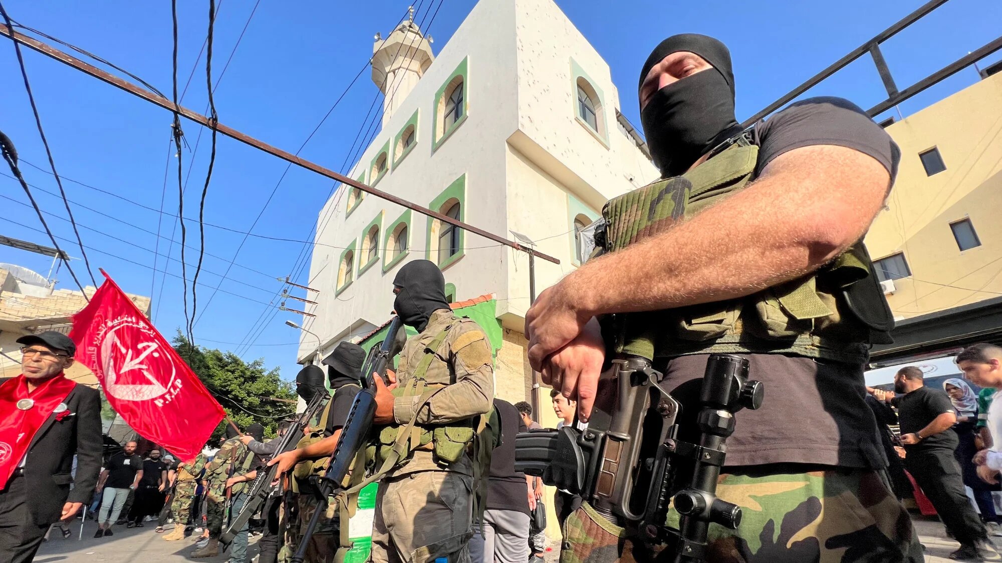 Armed men attend the funeral of two Popular Front for the Liberation of Palestine  members killed in southern Lebanon by Israeli forces, in Ein el-Hilweh refugee camp, Sidon, on 1 November 2024 (AFP/Mahmoud Zayyat)