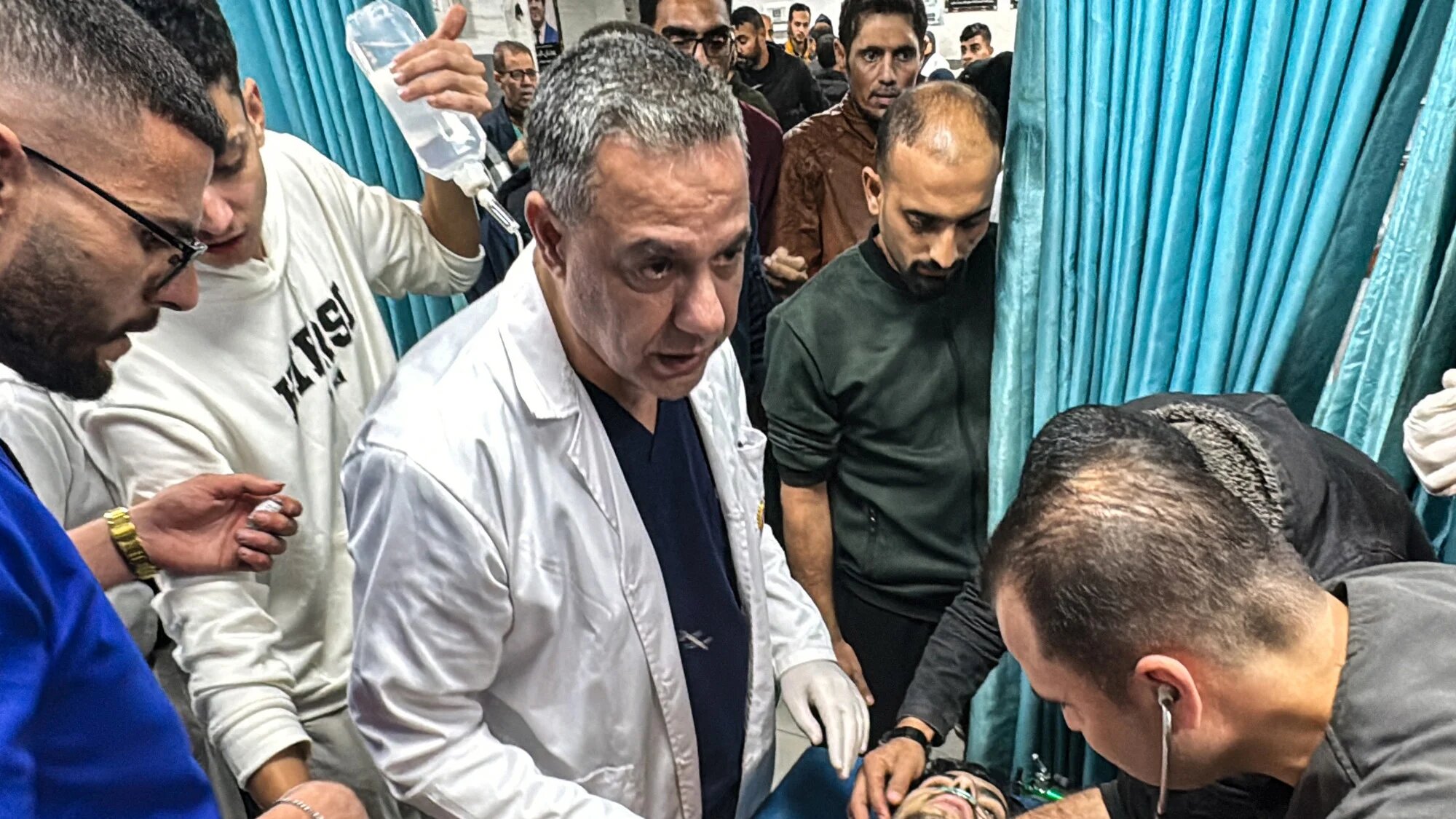 Hussam Abu Safieh, director of the Kamal Adwan hospital, supervises the treatment of a Palestinian man, wounded in an Israeli strike on Beit Lahia in the northern Gaza Strip on 21 November 2024 (AFP)