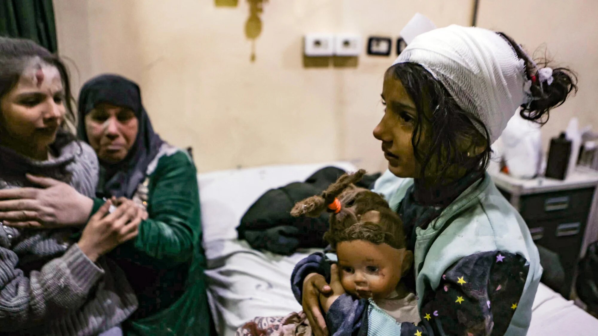 Young injured girls await treatment at a hospital following a pro-government forces strike that targeted a neighbourhood in Syria's rebel-held northern city of Idlib on 1 December 2024 (AFP/Aaref Watad)