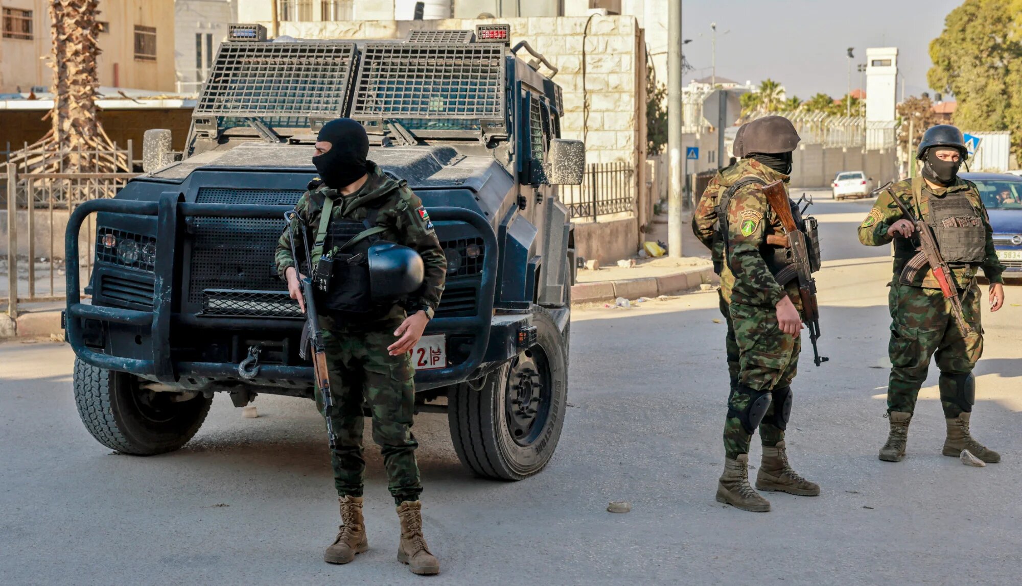 Palestinian security forces stand guard at a roadblock in the occupied-West Bank city of Jenin on 6 December 2024 (AFP/Jaafar Ashtiyeh)