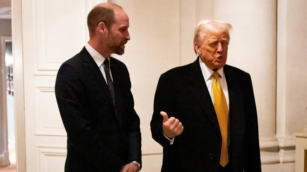 US President-elect Donald Trump (R) gestures towards Britain's Prince William, Prince of Wales (L), as he arrives for a meeting at the UK Ambassadors residence in Paris, on December 7, 2024 (AFP)