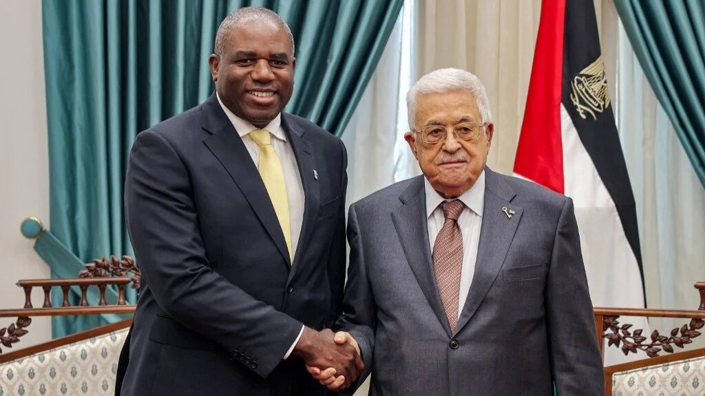 Palestinian President Mahmoud Abbas (R) receiving Britain's Foreign Secretary David Lammy at the presidential headquarters in Ramallah on January 13, 2025