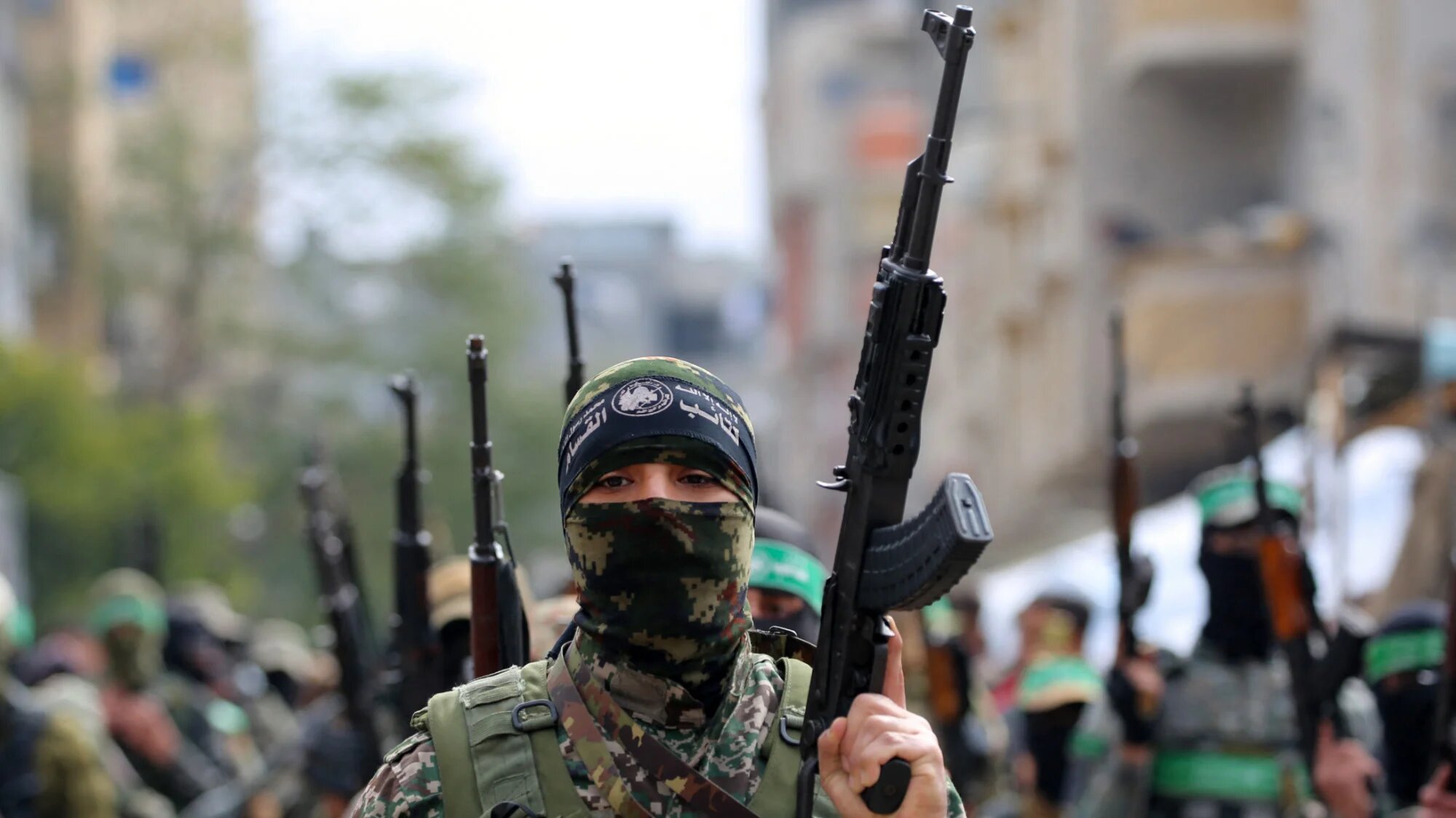 Palestinian fighters from the armed wing of Hamas take part in the funeral procession of Marwan Issa, a top Hamas commander killed in March 2024, in the Bureij refugee camp on 7 February 2025 (AFP/Eyad Baba)