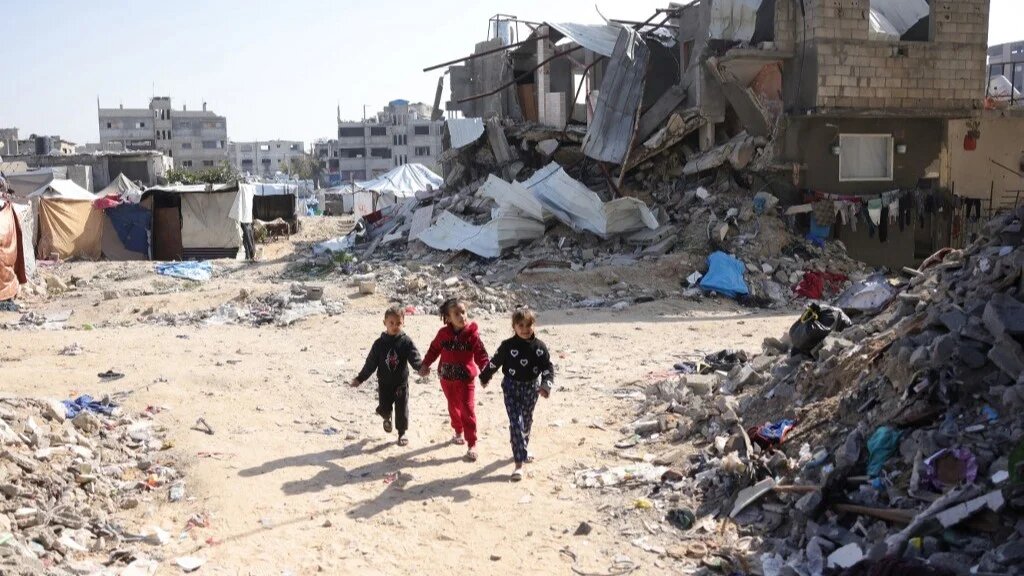 Palestinian children play amidst the rubble in Jabalia in the northern Gaza Strip on February 17, 2025