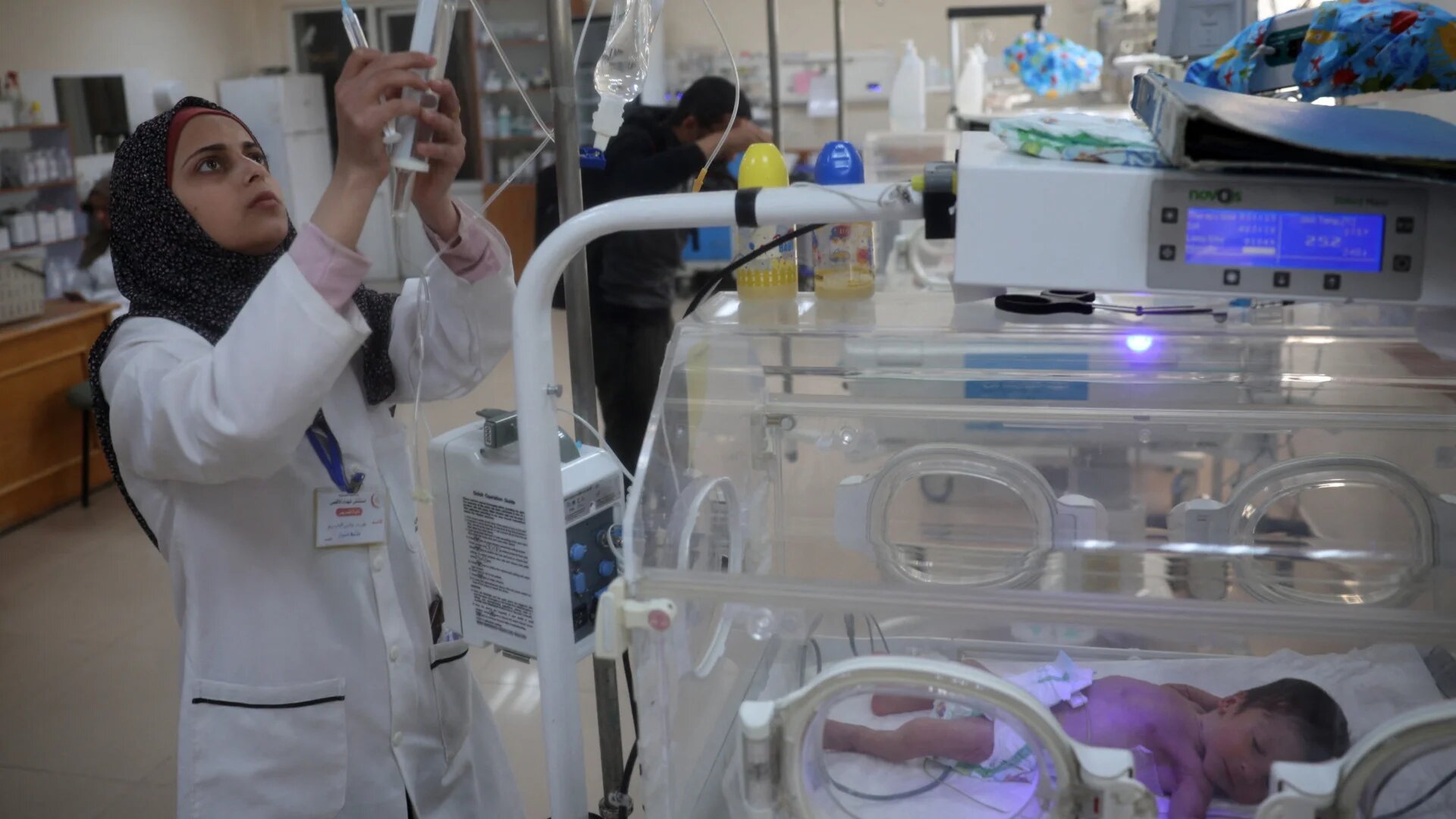 A nurse cares for a premature baby in an incubator at al-Aqsa Martyrs Hospital in Deir el-Balah on 15 March 2025, nearly a week after Israel cut electricity to Gaza (Eyad Baba/AFP)