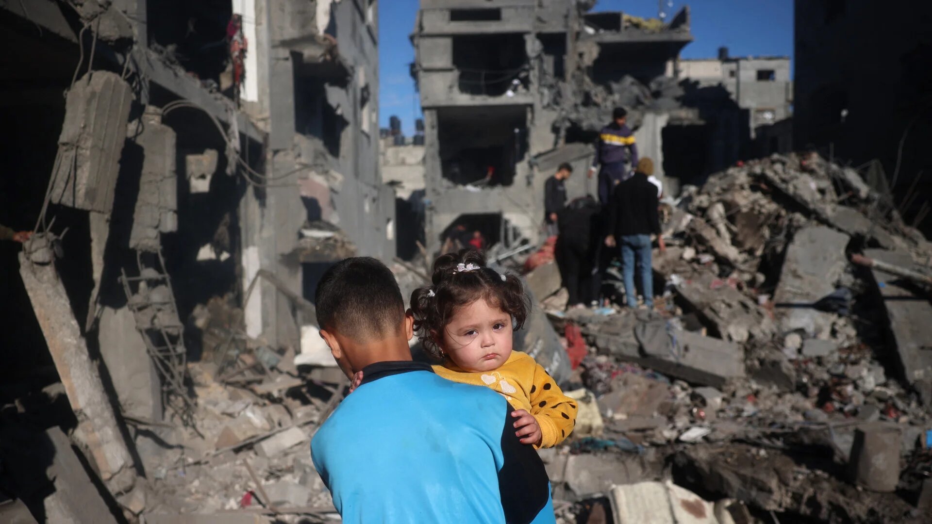 Palestinian children move through the rubble and debris at the site of Israeli strikes the night before at the Nuseirat refugee camp in the central Gaza Strip on 23 March 2025 (Eyad Baba/AFP)