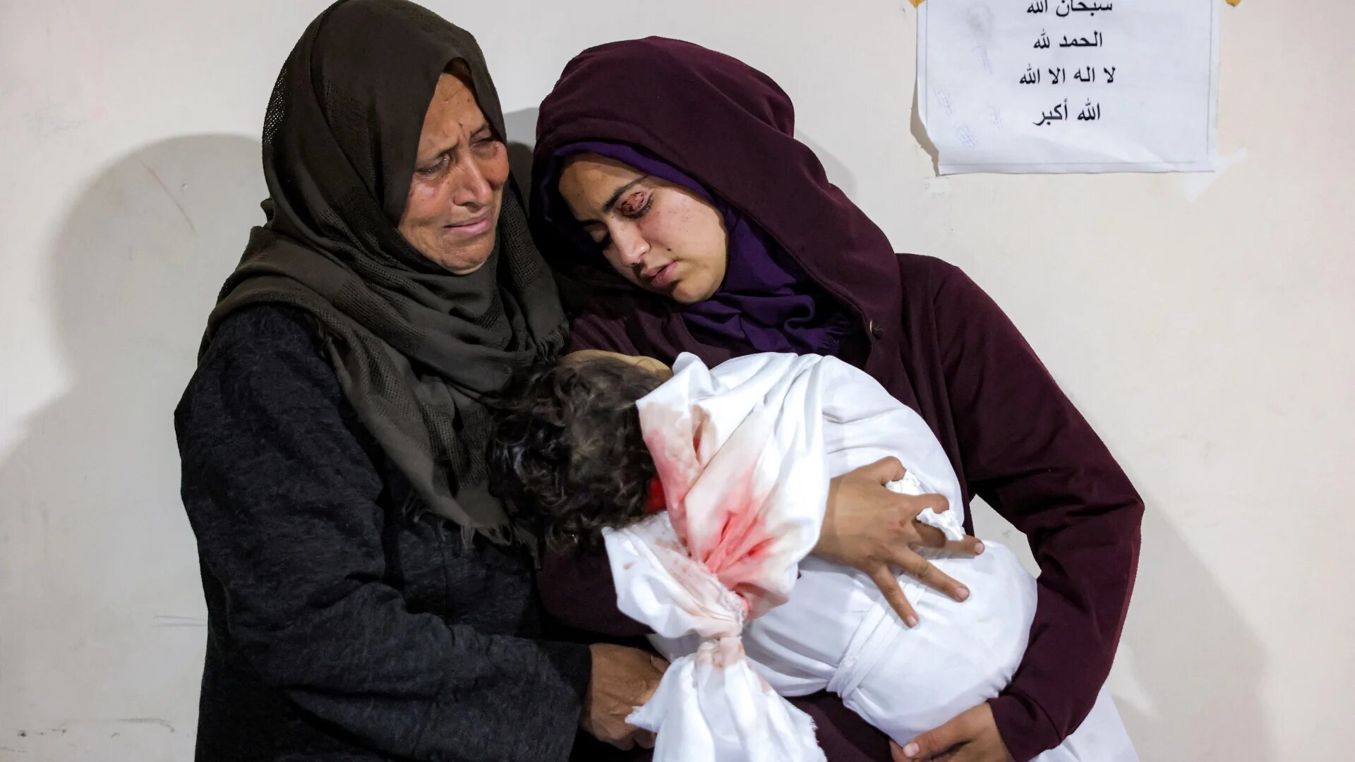 A Palestinian mother cradles the body of her daughter Ibtissam Elyan, who was killed when an Israeli air strike hit the family home in Beit Lahia in the northern Gaza Strip on 25 March 2025 (Bashar Taleb/AFP)