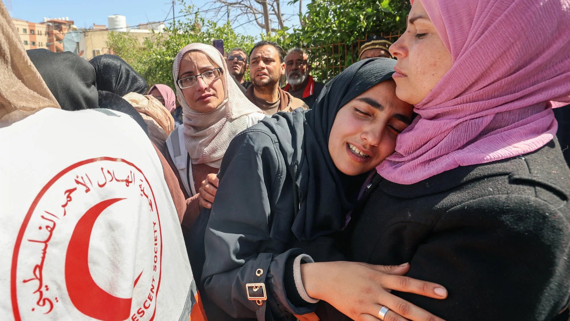 Relatives mourn during the funeral procession for members of the Palestine Red Crescent and other emergency services who were killed a week earlier by Israeli forces, at Nasser hospital in Khan Yunis in the southern Gaza Strip on 31 March 2025 (AFP/Eyad Baba)