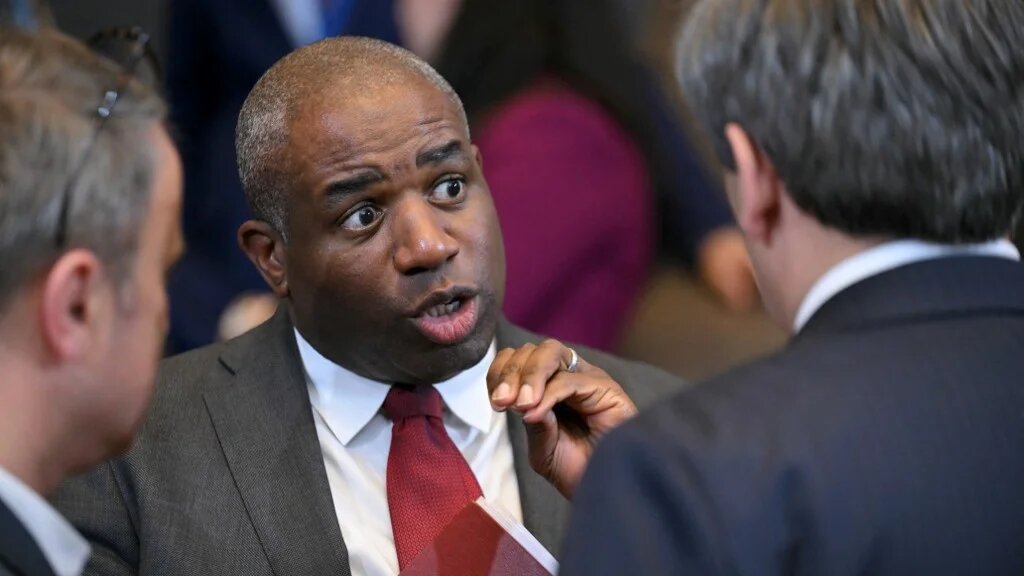 UK Foreign Secretary David Lammy speaks with other attendees before the start of a meeting of the North Atlantic Council in Brussels on 3 April. 