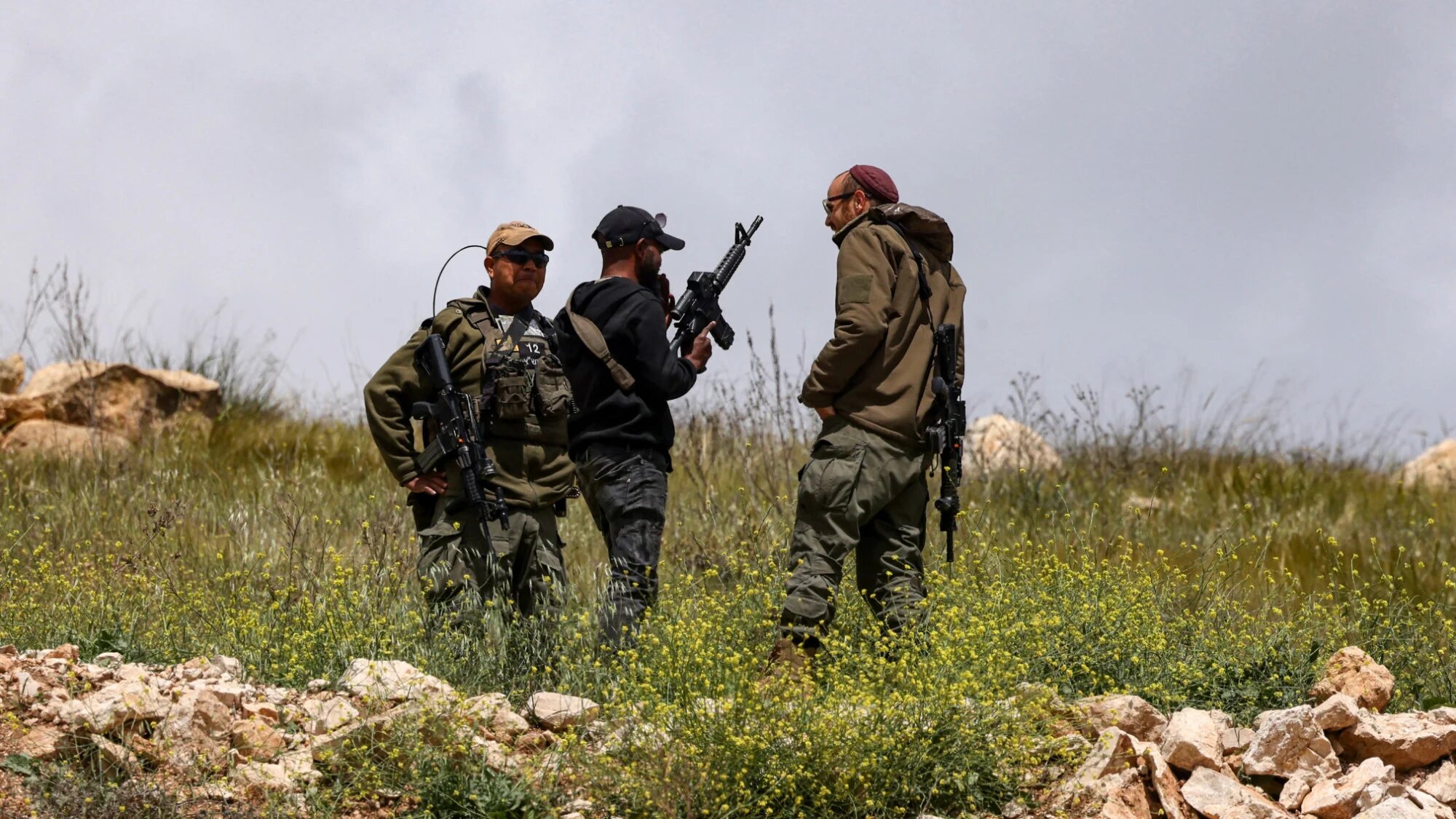 Israeli soldiers watch from a hill after army bulldozers demolished houses belonging to the Al-Hirsh family, in the village of Al-Rihaya, south the occupied West Bank city of Hebron on 10 April 2025 (AFP/Hazem Bader)