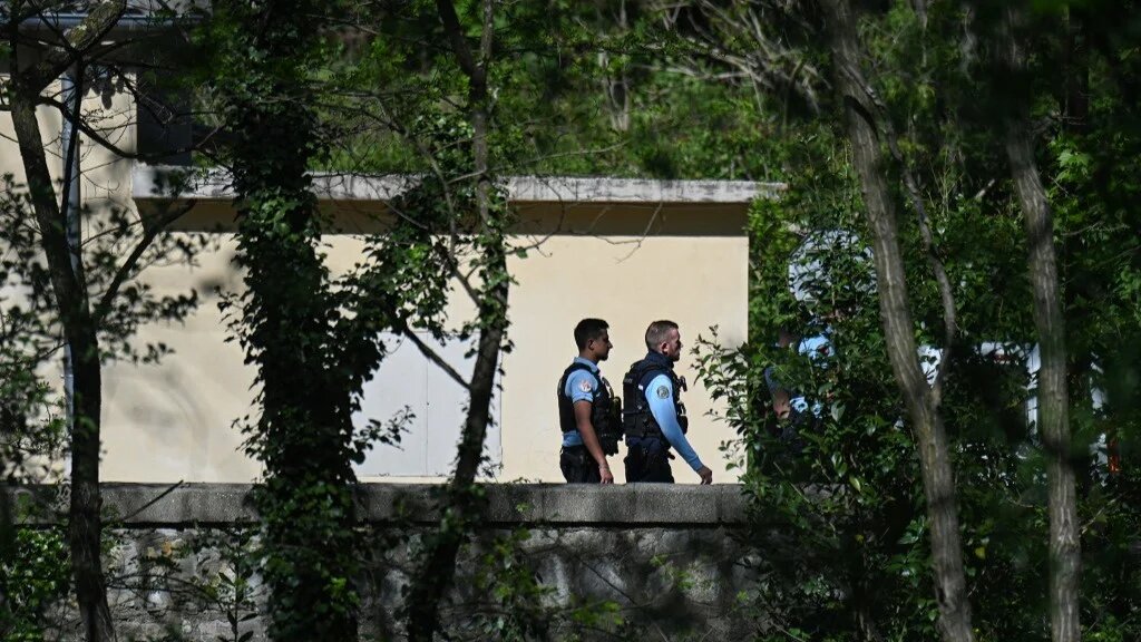 French gendarmes walk outside the local mosque of La Grand-Combe, southern France, on 25 April 2025, during an investigation after a Muslim worshipper was stabbed to death (AFP)