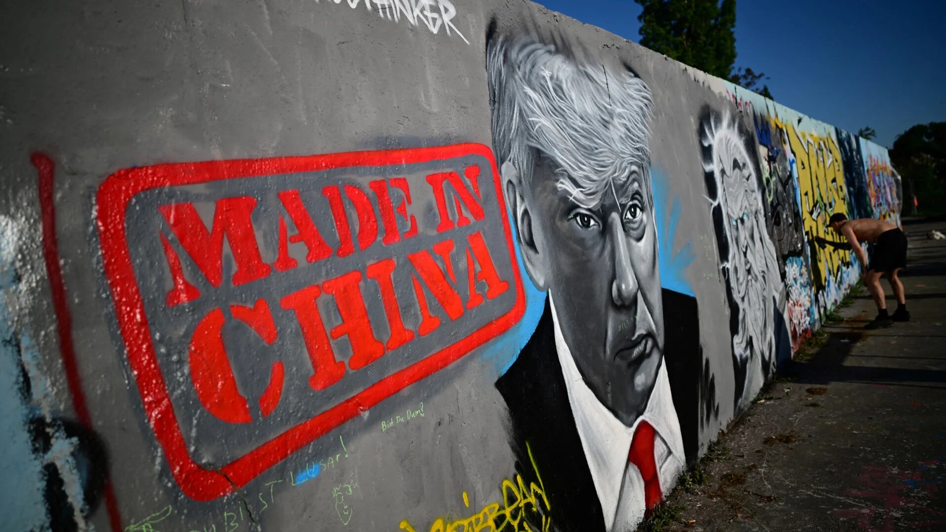 A mural by street artist Eme Freethinker at Mauerpark in Berlin shows US President Donald Trump with the words 'Made in China', as China's foreign minister condemns Trump's tariffs as an act of 'extreme selfishness', on 26 April 2025 (Tobias Schwarz/AFP)