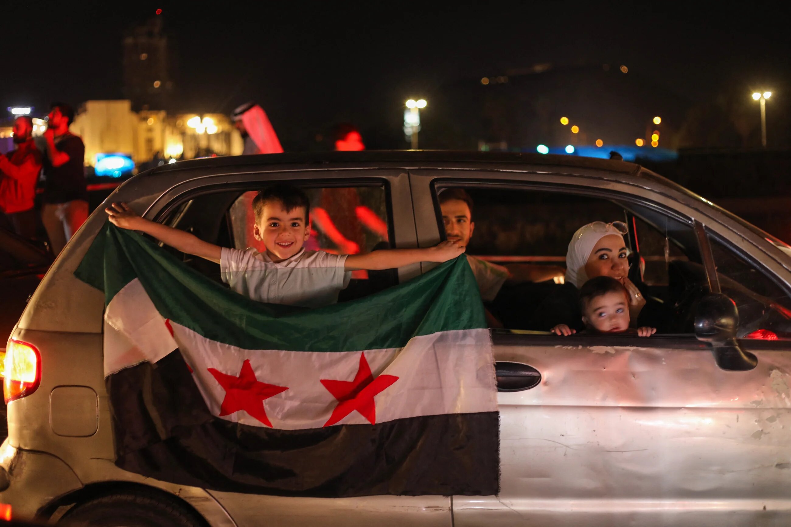 People celebrate in Damascus' Umayyad Square after US President Donald Trump's announcement that he would lift sanctions targeting Syria on 13 May 2025 (Abdulaziz Ketaz/AFP)