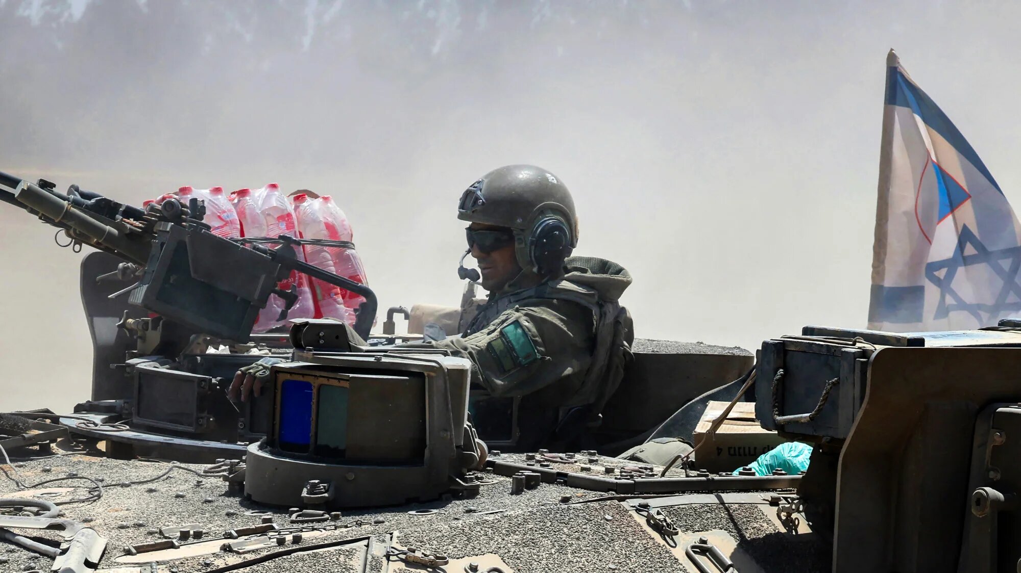 An Israeli soldier in a military vehicle near the Gaza boundary, 20 May 2025 (AFP/Jack Guez)