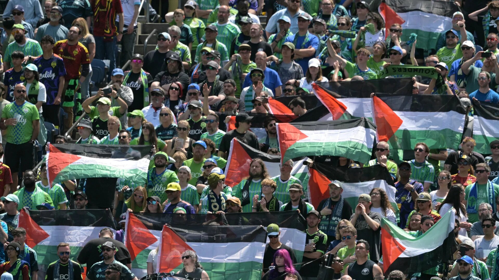 Fans hold Palestinian flags during the Fifa Club World Cup Group B match between Seattle Sounders and Paris Saint-Germain at Lumen Field stadium in Seattle, United States, on 23 June 2025 (Juan Mabromata/AFP)