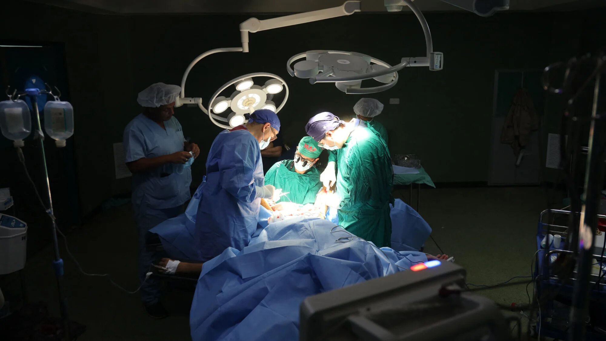 Surgeons operate on a wounded Palestinian at the Nasser hospital in Khan Yunis in the southern Gaza Strip on 11 July 2025 amid severe fuel shortages (AFP)