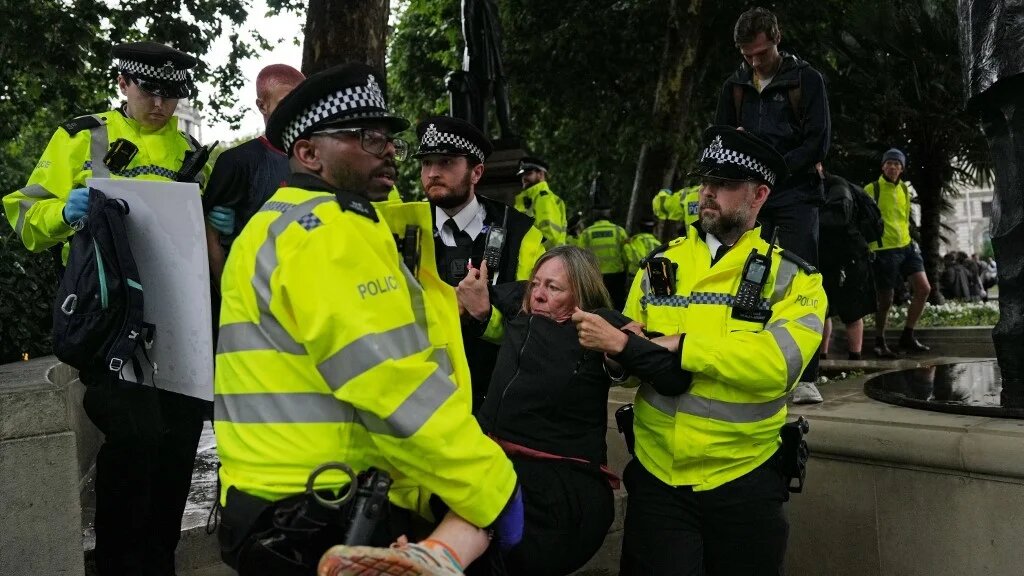 A protester is carried away by police officers at a demonstration in support of the proscribed group Palestine Action calling for the recently imposed ban to be lifted, in Parliament Square, central London, on July 19, 2025