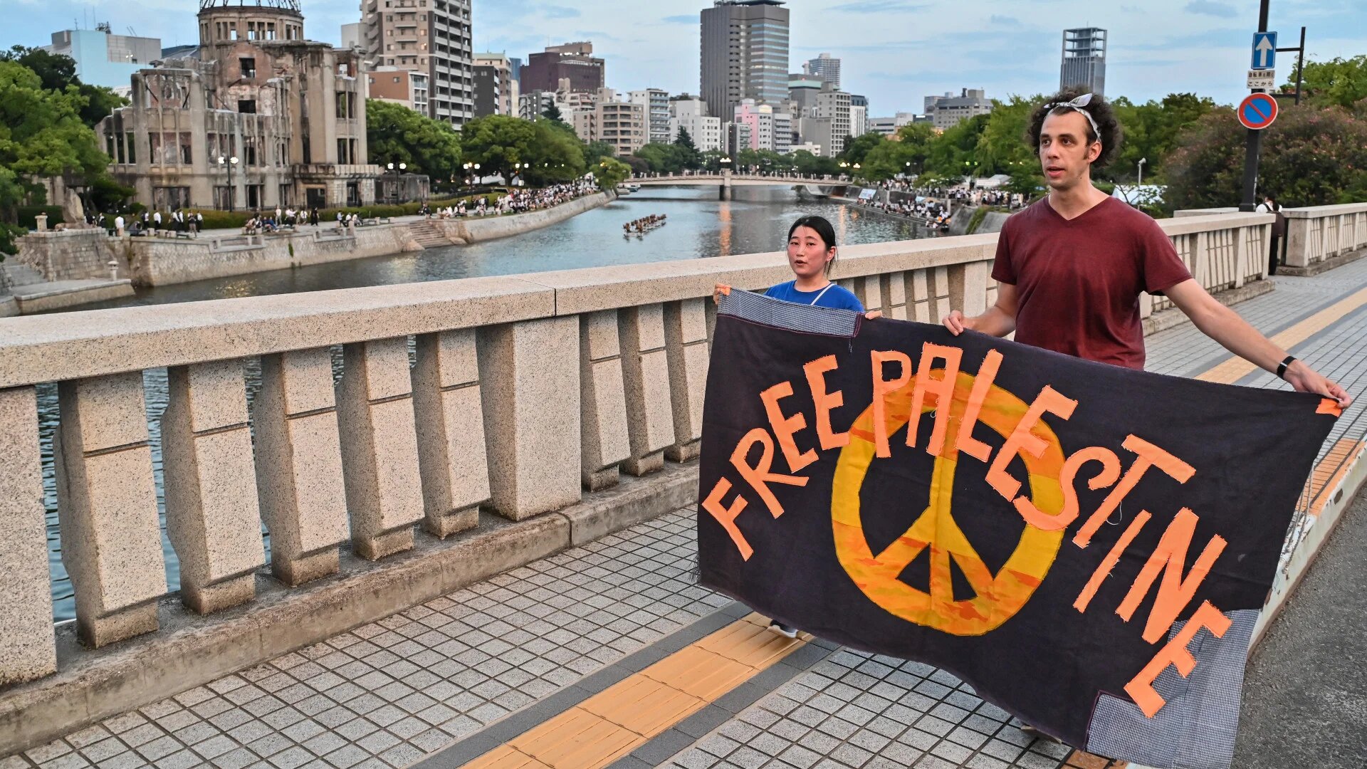 Protesters in Hiroshima carry a 'Free Palestine' banner past the Atomic Bomb Dome (background left) 80 years on from the explosion that hit that hit the city (Richard A Brooks/AFP)