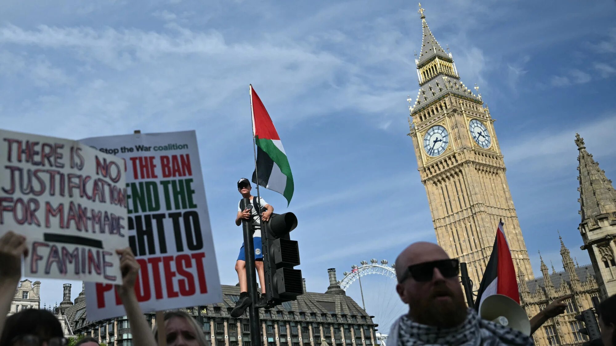 Protesters hold placards and wave Palestinian flags at a "Lift The Ban" demonstration in support of the proscribed group Palestine Action in Parliament Square, central London, on 6 September 2025 (AFP/Justin Tallis)