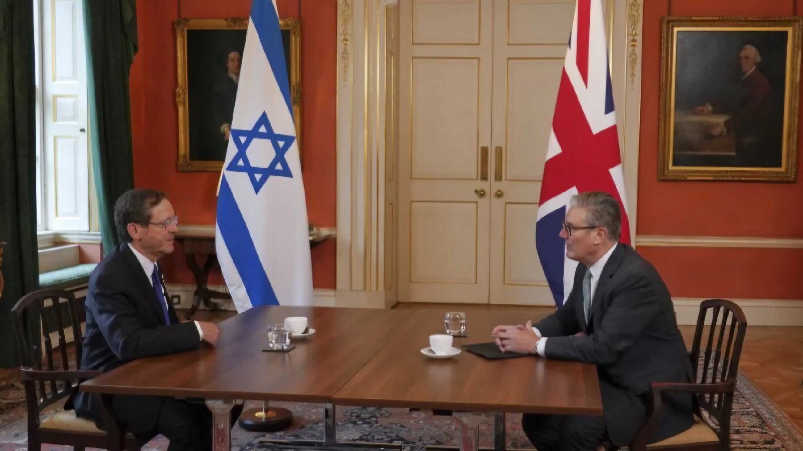 Britain's Prime Minister Keir Starmer (R) and Israel's President Isaac Herzog (L) pose at the start of their meeting in 10 Downing Street in central London on September 10, 2025