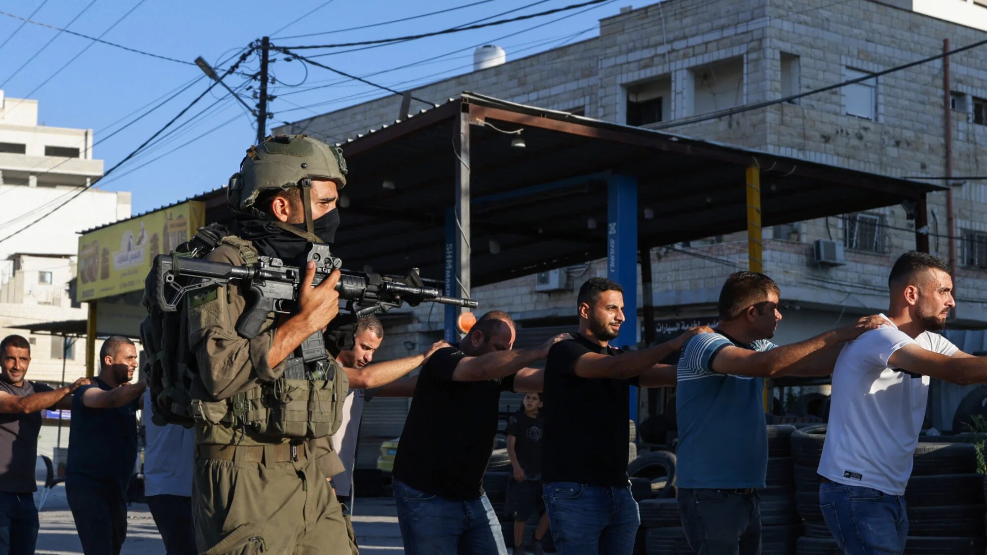 Israeli soldiers detain Palestinians during a raid following the reported explosion of an Israeli military vehicle near a checkpoint west of Tulkarem in the occupied West Bank on 11 September 2025 (AFP/Jaafar Ashtiyeh)