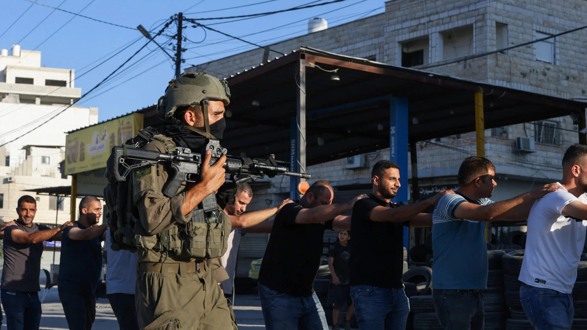 Israeli soldiers detain Palestinians during a raid following the reported explosion of an Israeli military vehicle near a checkpoint west of Tulkarem in the occupied West Bank on 11 September 2025 (AFP/Jaafar Ashtiyeh)