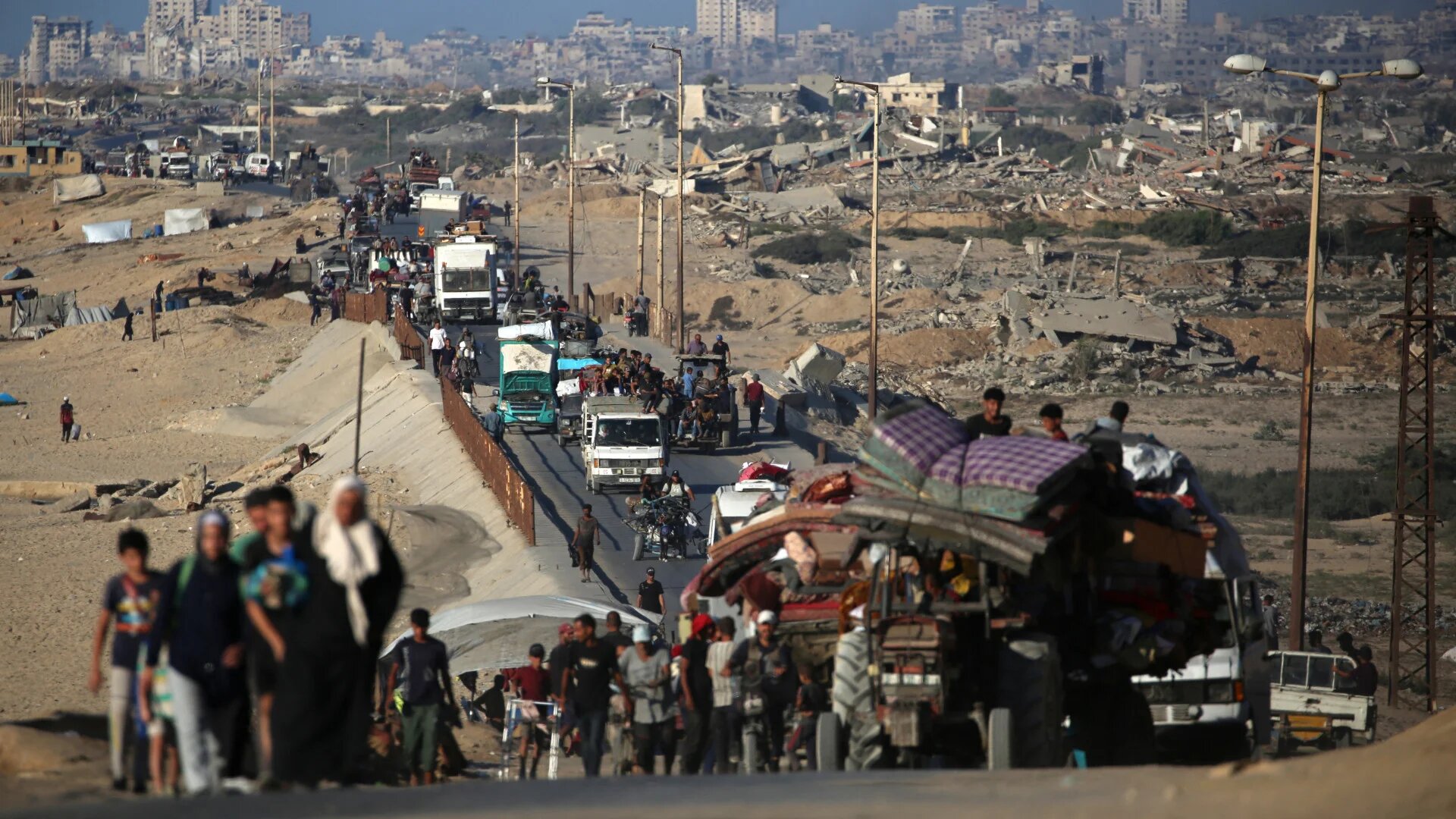 Palestinians flee south from Gaza City with their belongings under Israeli expulsion orders, along the coastal road near Nuseirat refugee camp in central Gaza, 12 September 2025 (Eyad Baba/AFP)