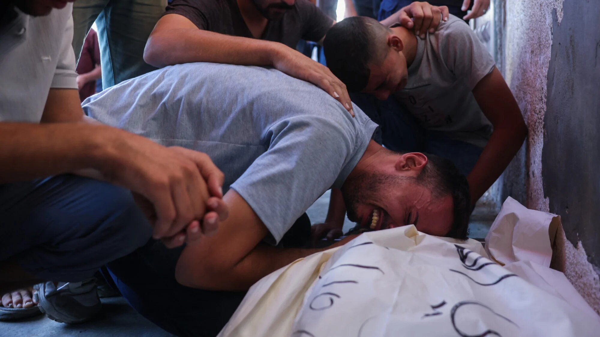 Palestinians mourn by the body of a relative who was killed in Israeli strikes in Deir al-Balah, at Al-Aqsa Martyrs Hospital in the central Gaza Strip on 2 October 2025 (AFP/Bashar Taleb)