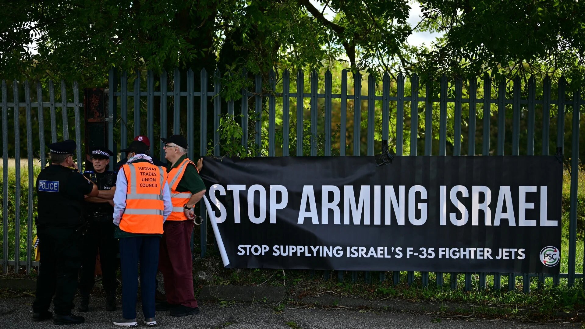 Pro-Palestinian protesters display a banner outside a BAE Systems facility in Rochester, England, calling on the British government to impose a full arms embargo on Israel, 8 October 2025 (Ben Stansall/AFP)