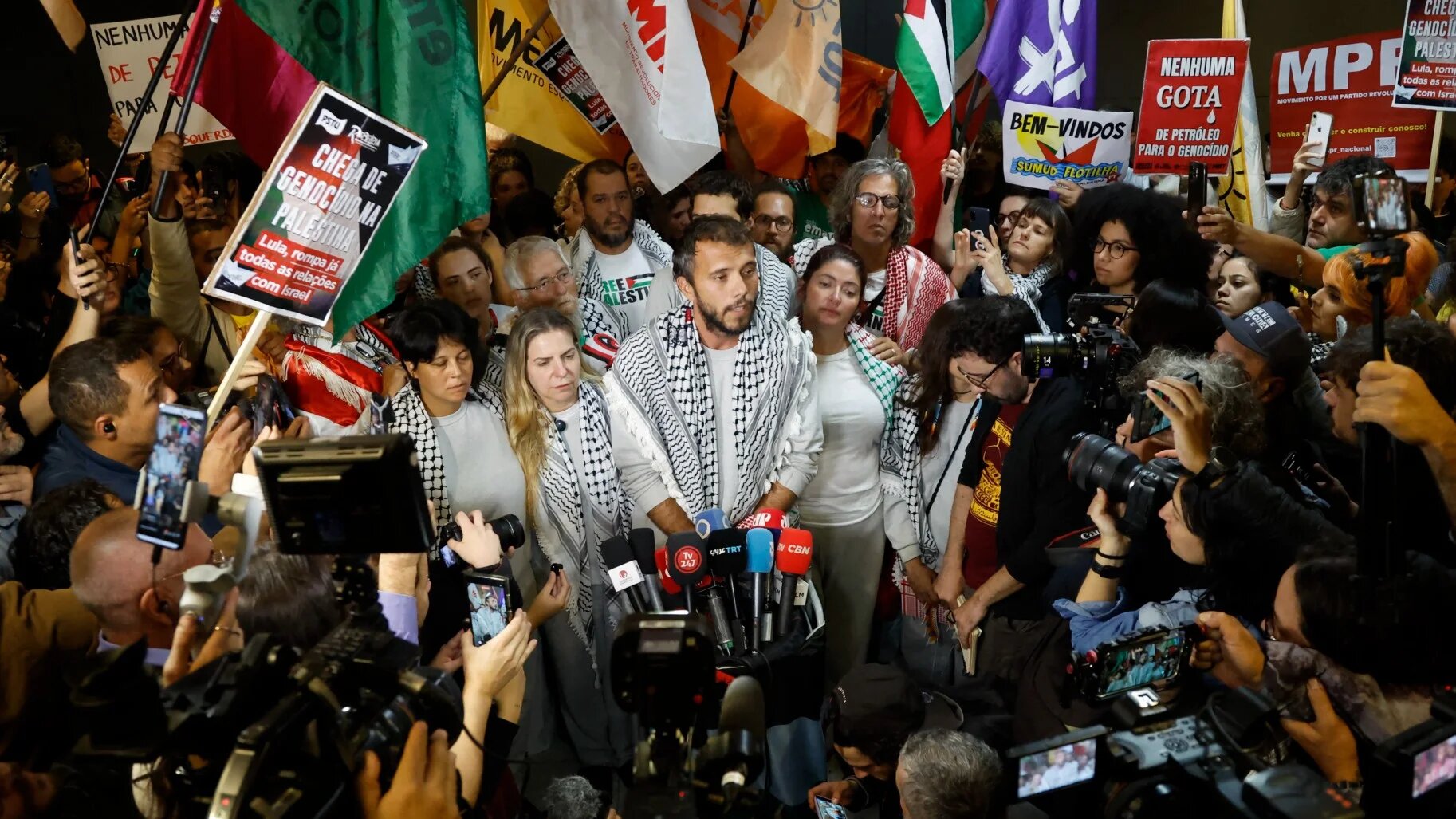 Global Sumud Flotilla activists speak to the media upon arriving at Guarulhos International Airport after being released by Israeli authorities, 9 October 2025 (Miguel Schincariol/AFP)