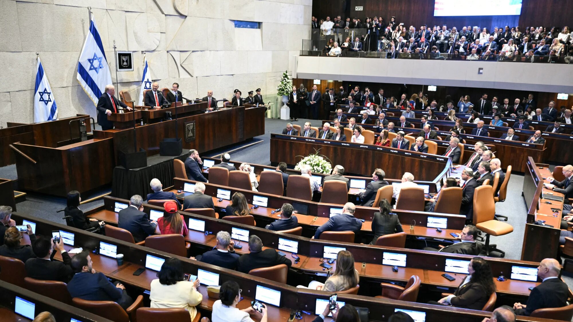 US President Donald Trump (L) addresses the Israeli parliament, the Knesset, in Jerusalem on 13 October 2025 (Saul Loeb/AFP)