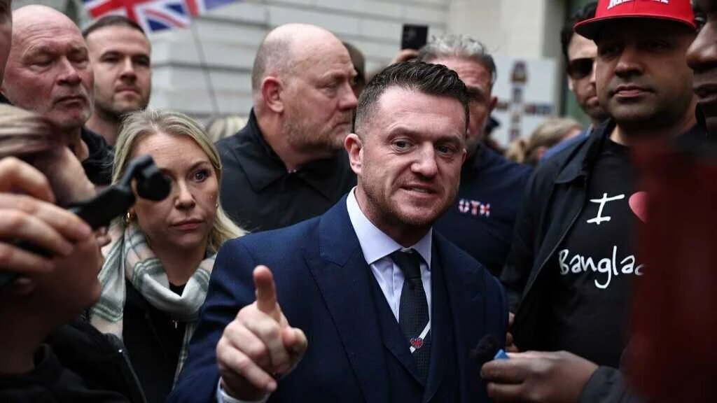 British far-right activist Tommy Robinson, whose real name is Stephen Yaxley-Lennon, arrives at Westminster Magistrates Court in London on October 13, 2025, after being charged with failing to provide the PIN to his mobile phone.