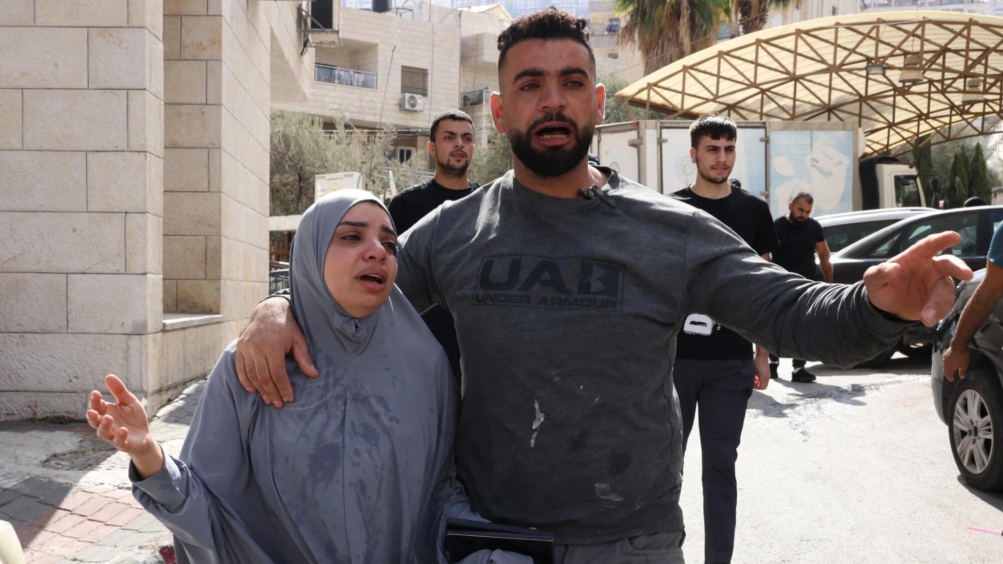 Wife of Majed Mohammed Daoud, a 42-year-old Palestinian killed by Israeli forces, is comforted by a relative in the occupied West Bank city of Nablus on 19 October 2025 (AFP/Hazem Bader)