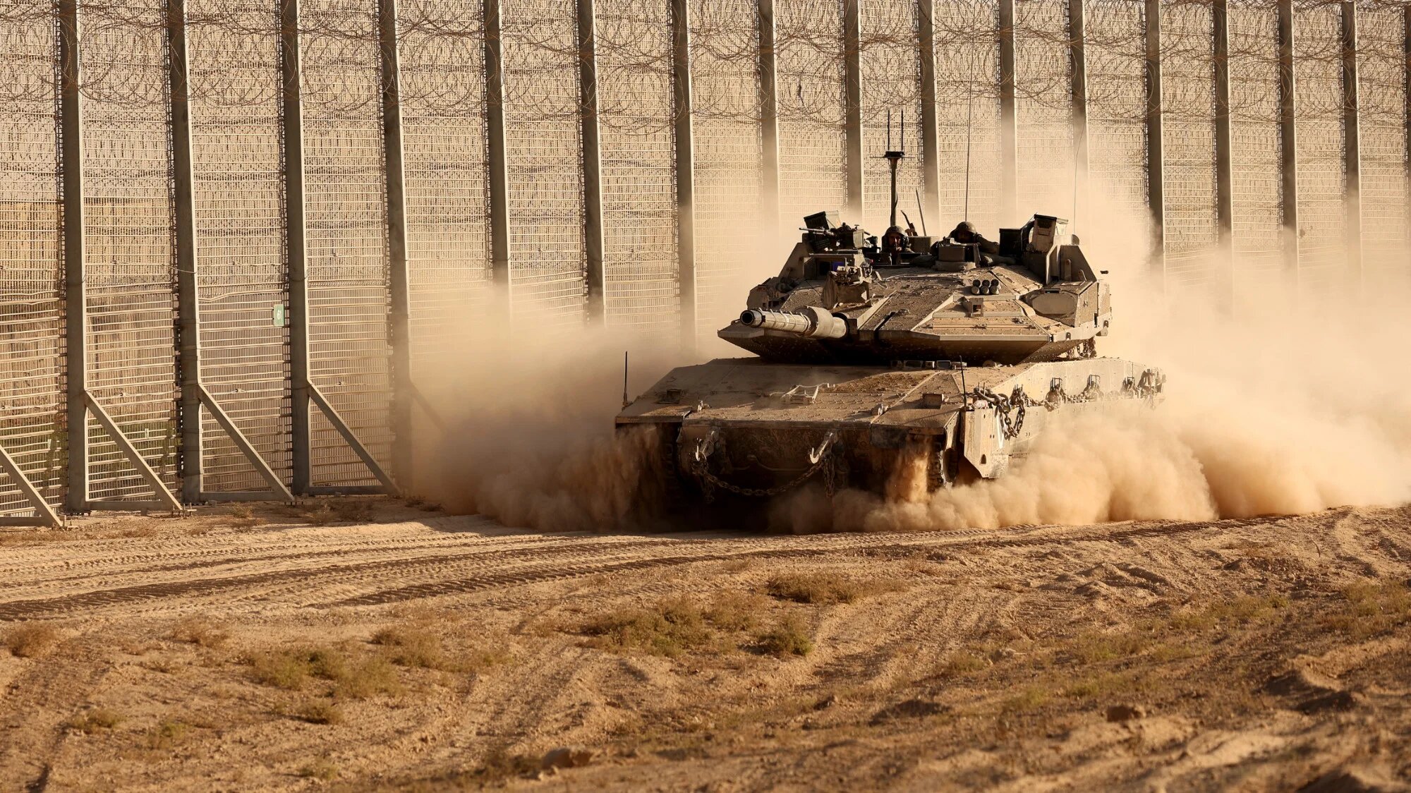 An Israeli army tank moves along the fence between Israel and the Gaza Strip on 21 October 2025 (Jack Guez/AFP)