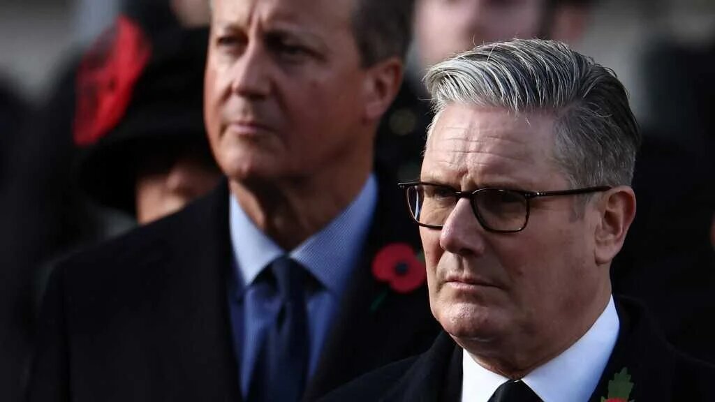 Britain's Prime Minister Keir Starmer (R) and former prime minister David Cameron (L) attend the Remembrance Sunday ceremony at the Cenotaph on Whitehall in central London on November 9, 2025. 