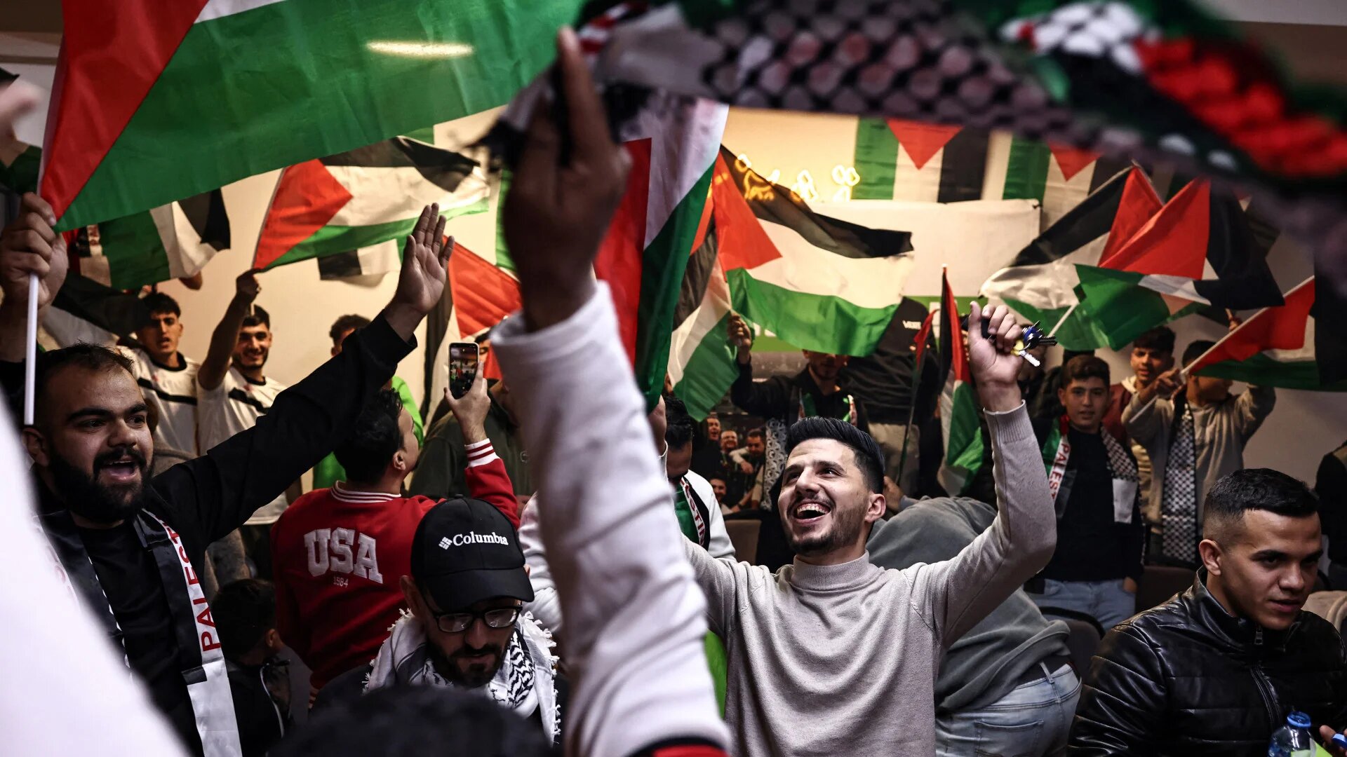 Palestinian football fans gather at a cafe in Ramallah in the Israeli-occupied West Bank on 7 December 2025 to watch their national team play Syria in the Arab Cup in Qatar (Zain Jaafar/AFP)