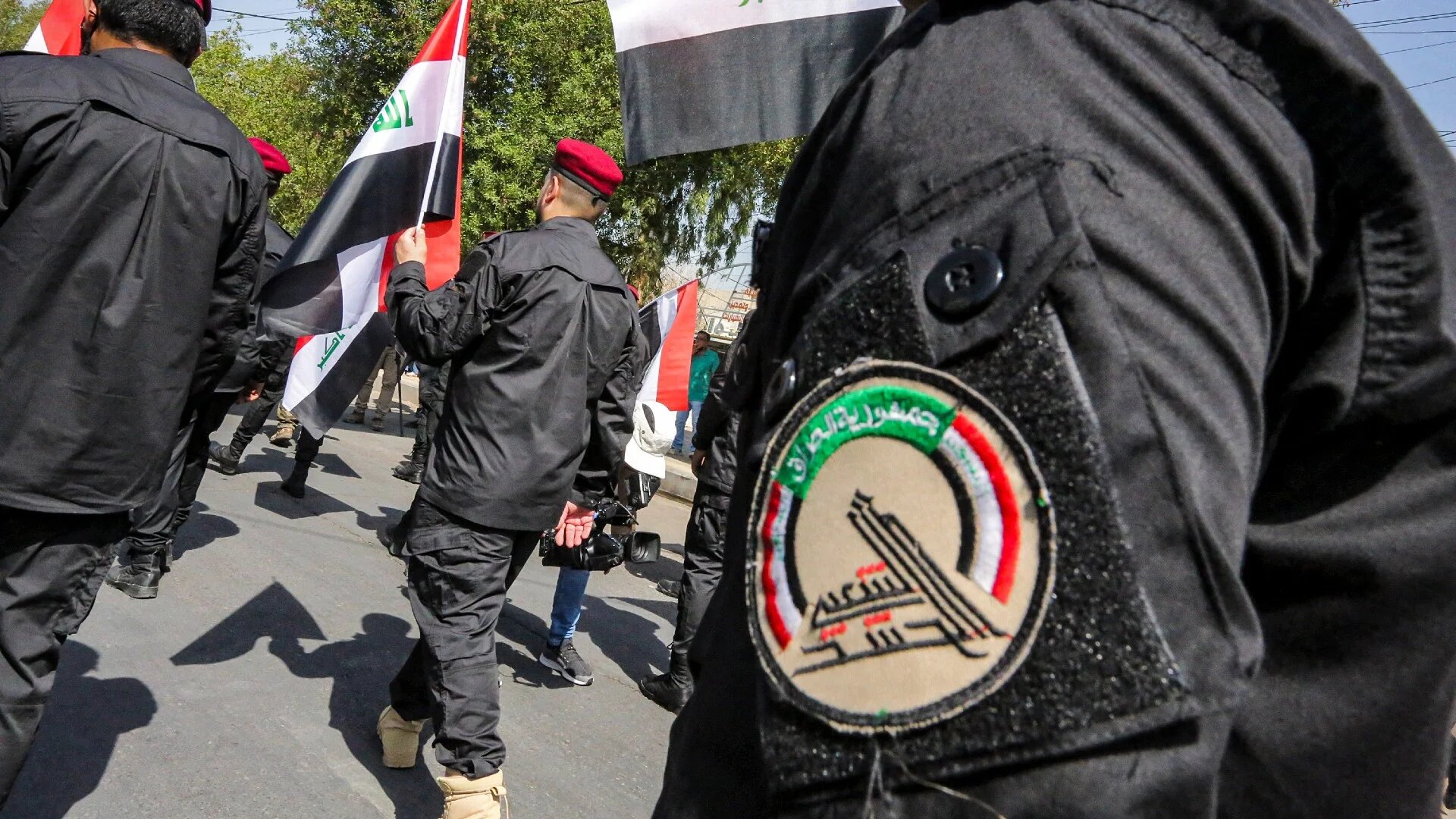 Members of Iraq's Hashd al-Shaabi paramilitary forces march in a symbolic funerary parade in the capital Baghdad in 2021 (AFP)