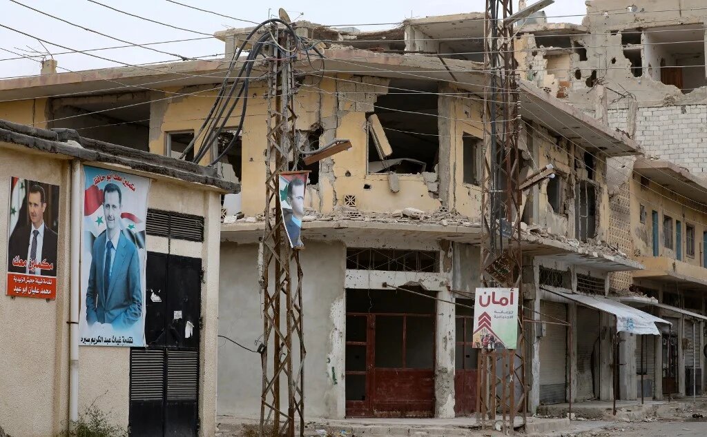 Damage pictured in a street in the Syrian town of al-Qaryatain in Homs province, on December 2021, inflicted by battles in 2015 between the Islamic State group (IS) and government forces (AFP)