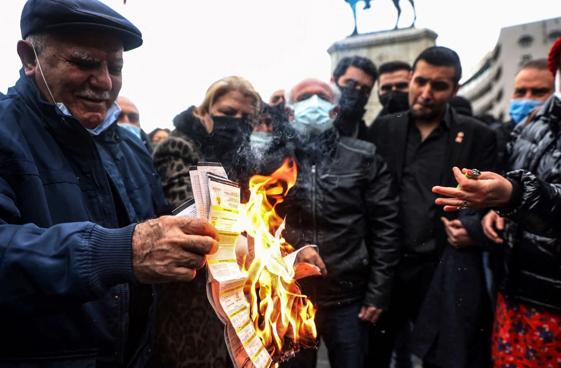 People burn their electricity bills as a protest against high energy prices in on February 9, 2022 (AFP)