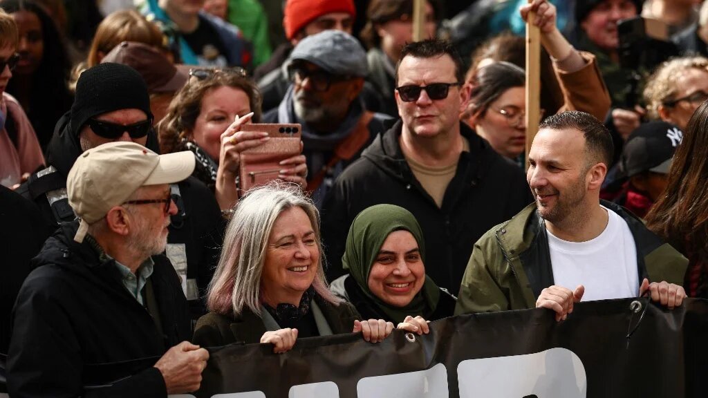 Green Party leader Zack Polanski (R) and former Labour party leader Jeremy Corbyn (L) join protesters holding placards and waving flags as they take part in a march against the far right, organised by the Together Alliance, in central London on March 28, 2026.
