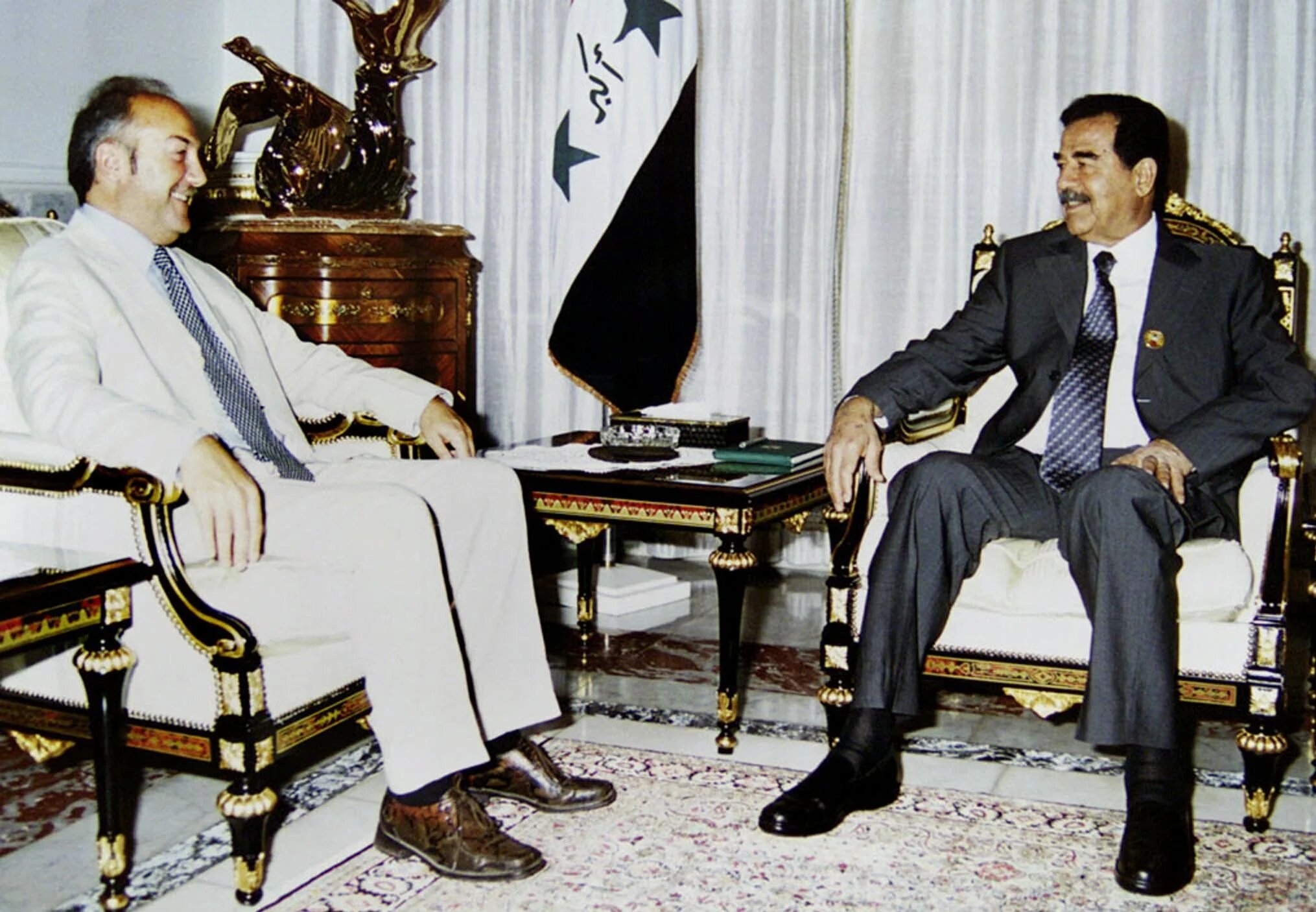 President Saddam Hussein (R) meeting with British Labour MP George Galloway on 8 August 2002 in Baghdad, Iraq (AFP/INA)