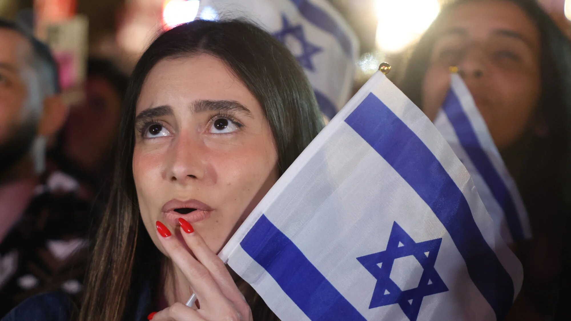 A woman reacts as people gather at the Tel Aviv 360, a giant beachfront stage in Tel Aviv on 16 May 2026, to watch the final of the Eurovision Song Contest 2026 (Jack Guez/AFP)