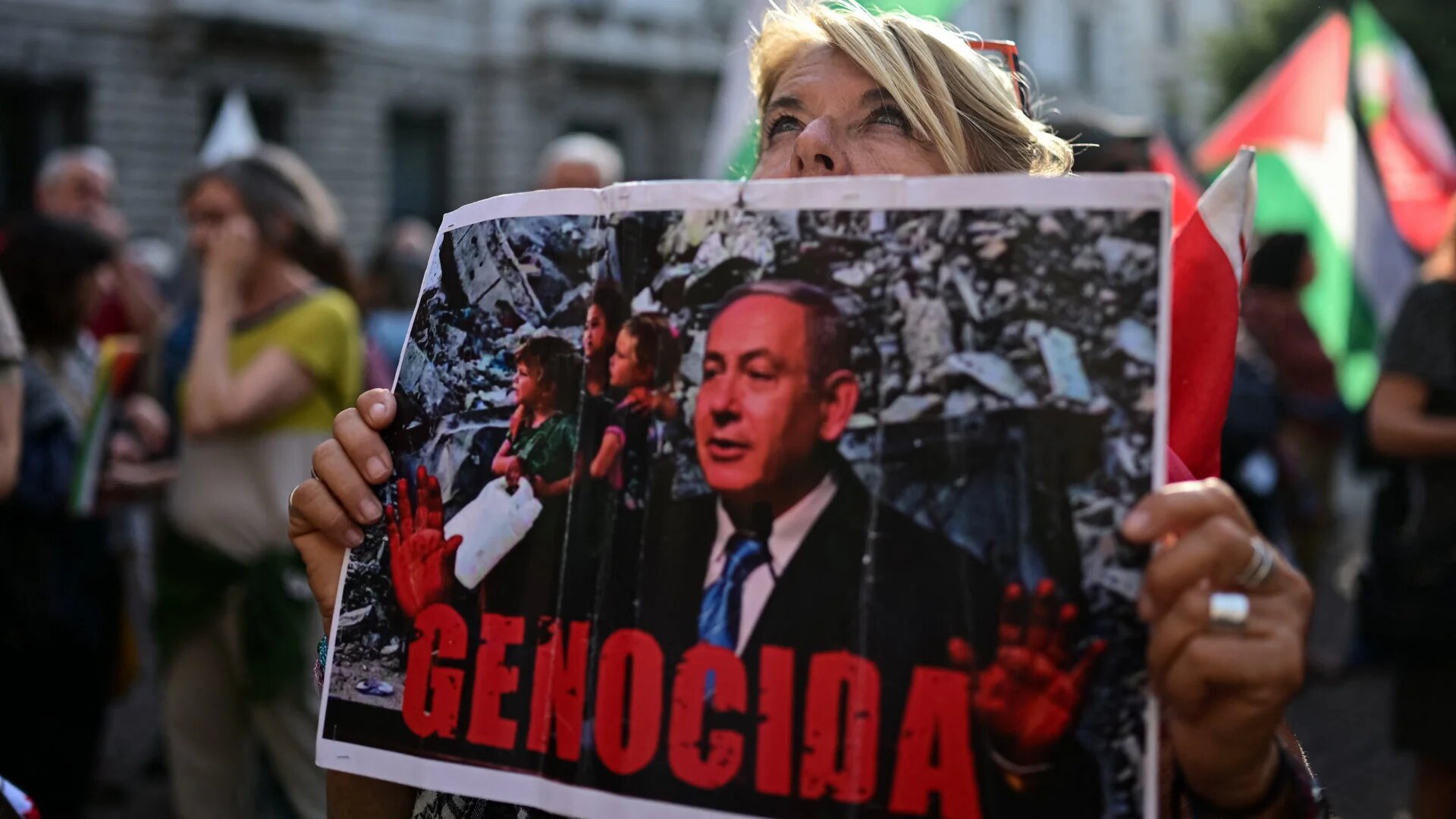 A protester holds a placard depicting Israeli Prime Minister Benjamin Netanyahu during a demonstration in Milan on 21 May 2026 (Piero Cruciatti/AFP)