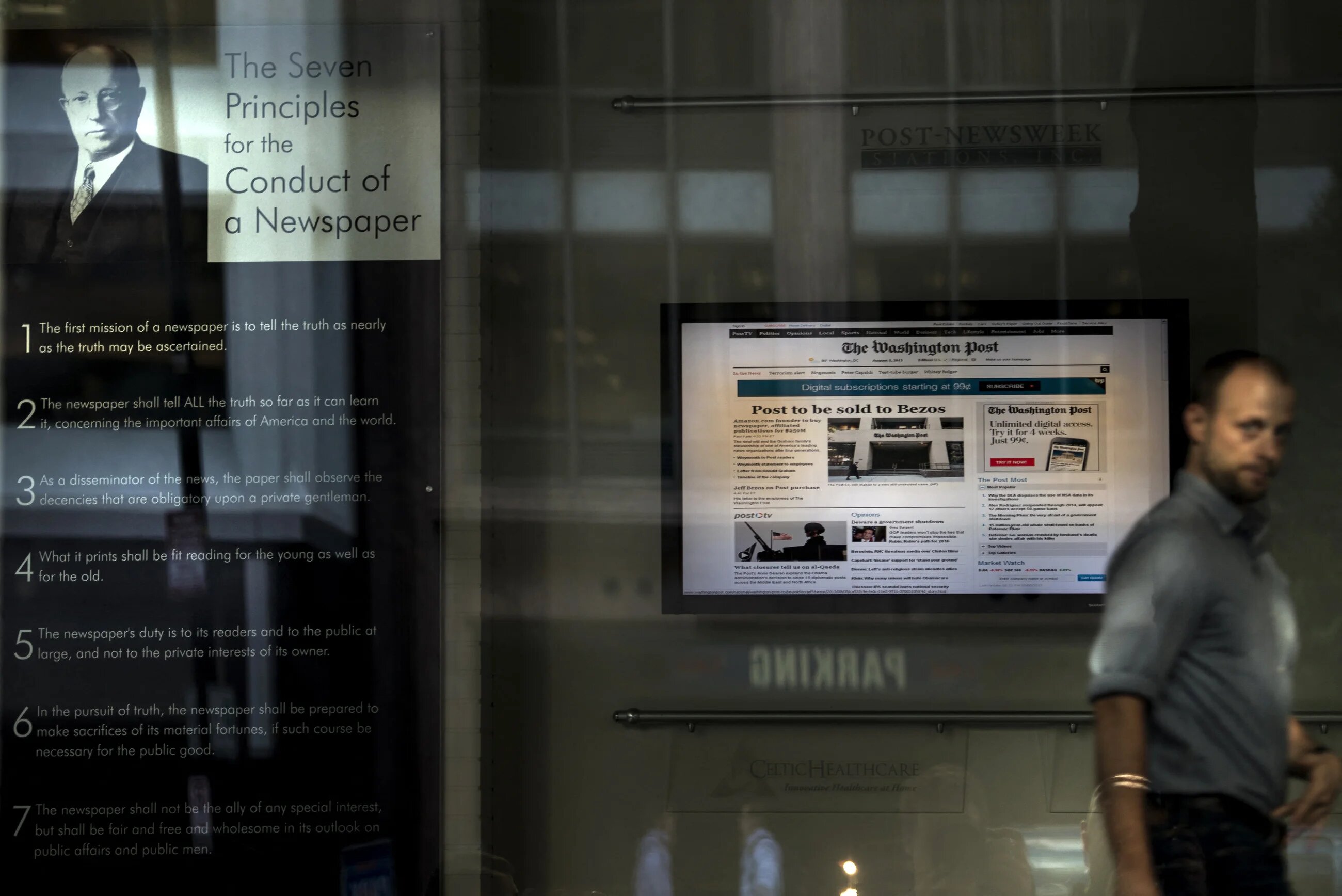 A man walks through the lobby of the Washington Post on 5 August 2013 in Washington, DC (Brendan Smialowski/AFP)
